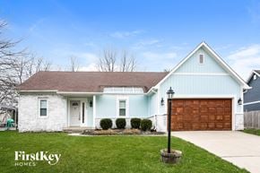 Fishers house for rent - a blue and white house with a garage door