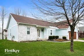 Fishers house for rent - a white brick house with blue walls and a yard