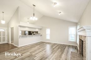 Fishers house for rent - the living room and dining room with a fireplace and wood flooring
