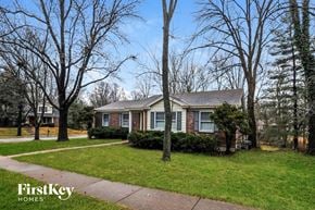 Ballwin house for rent - a small brick house with a sidewalk in front of it