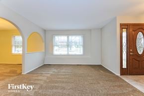 Ballwin house for rent - an empty living room with a door and a window