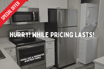 St. Petersburg apartment for rent - A kitchen with a stove, microwave, and refrigerator is on sale.