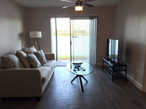 St. Petersburg apartment for rent - A living room with a couch, a coffee table, and a television.