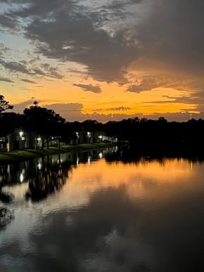 St. Petersburg apartment for rent - A serene lake reflects the sunset sky and the surrounding landscape.
