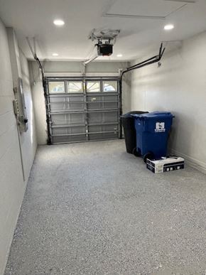 St. Petersburg house for rent - a empty garage with two trash cans in it
