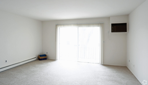 Trenton apartment for rent - an empty living room with white walls and a sliding glass door