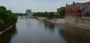 Cambridge apartment for rent - a river with buildings on either side and a bridge in the background
