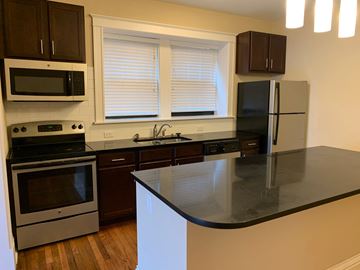 St. Louis apartment for rent - a kitchen with black counter top and stainless steel appliances
