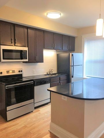 St. Louis apartment for rent - a kitchen with stainless steel appliances and black counter tops