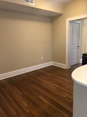 St. Louis apartment for rent - a living room with wooden floors and a white door