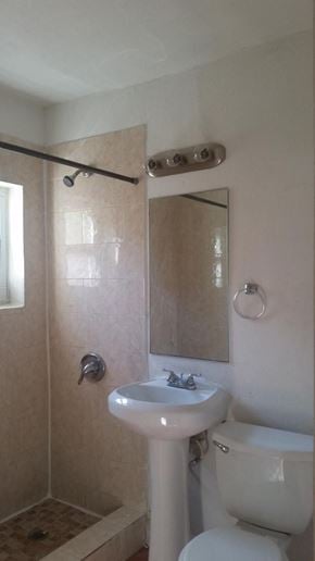 Miami apartment for rent - a bathroom with a sink and a toilet and a mirror