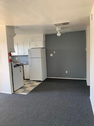 Albuquerque apartment for rent - A kitchen with a refrigerator and cabinets.