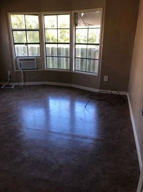 Eunice house for rent - A room with a large window and a fan on the wall.