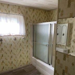 Eunice house for rent - a bathroom with a shower and a sink and a window