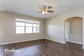 Valrico house for rent - A room with a ceiling fan and wooden flooring.