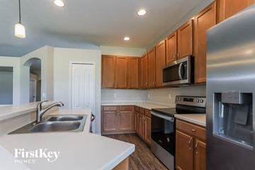 Valrico house for rent - A kitchen with wooden cabinets and stainless steel appliances.