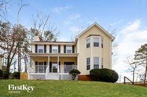 Alabaster house for rent - A two story house with a porch and a white picket fence.