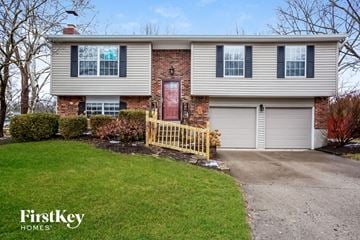 Fishers house for rent - a white house with a wooden fence in front of a lawn