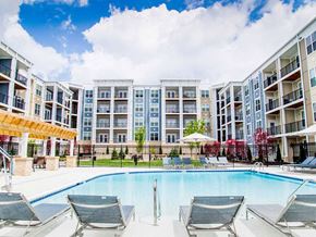 Miamisburg apartment for rent - a swimming pool in front of an apartment building