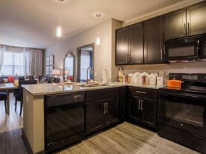 Miamisburg apartment for rent - a large kitchen with black cabinets and a counter top