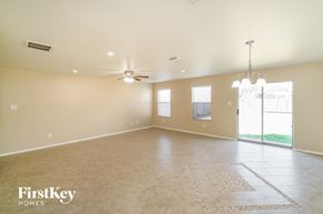 Converse house for rent - an empty living room with a ceiling fan and a window