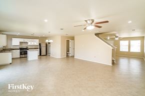 Converse house for rent - an open kitchen and living room with a ceiling fan