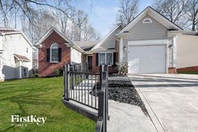 Charlotte house for rent - a black wrought iron gate in front of a house