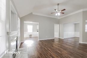 Charlotte house for rent - the living room and dining room with wood flooring and a ceiling fan