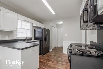 Charlotte house for rent - a kitchen with a stove and a refrigerator and a sink