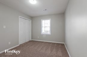 Charlotte house for rent - a bedroom with a carpeted floor and a window