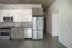 Nashville apartment for rent - a modern kitchen with stainless steel appliances and white cabinets
