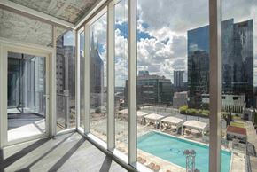Nashville apartment for rent - a view of a pool and a city from a balcony