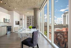 Nashville apartment for rent - a dining room with a table and chairs and a large window