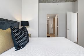 Nashville apartment for rent - a bedroom with a large bed and a black and white pillow