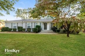 Gastonia house for rent - a white house with a lawn and a tree