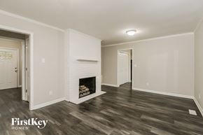 Gastonia house for rent - the living room has a fireplace and hardwood floors