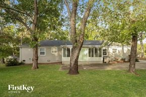 Gastonia house for rent - a gray house with trees in front of it