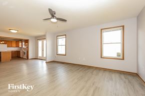 Commercial Point house for rent - A spacious room with a ceiling fan and wooden flooring.
