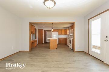 Commercial Point house for rent - A kitchen with wooden cabinets and a white refrigerator is shown in a FirstKey Homes property.