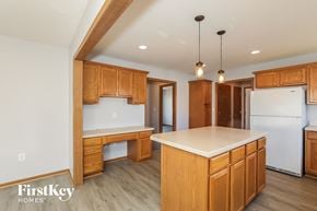 Commercial Point house for rent - A kitchen with wooden cabinets and a white countertop.