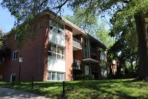 Guelph apartment for rent - A red brick building with white trim and windows.