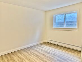 Guelph apartment for rent - A room with a window and wooden flooring.