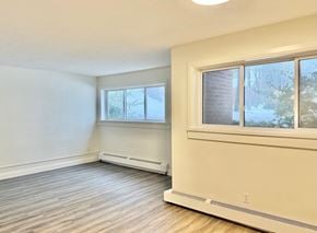 Guelph apartment for rent - A room with a window and a wall-mounted air conditioner.