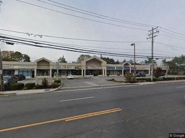 Commack apartment for rent - an empty intersection with a shopping center and a parking lot