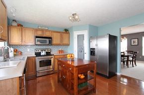 Morrow house for rent - a kitchen with wooden cabinets and stainless steel appliances