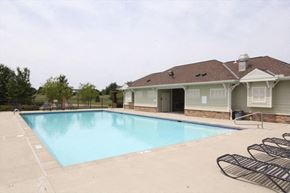 Morrow house for rent - a swimming pool with chairs in front of a house