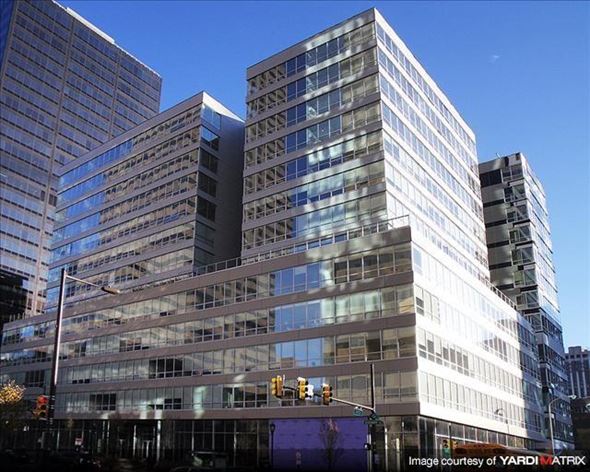 Philadelphia apartment for rent - a tall building with many windows in front of other tall buildings