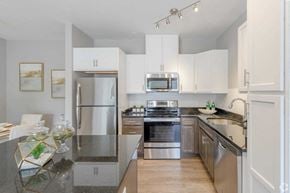 Boylston apartment for rent - a kitchen with stainless steel appliances and white cabinets