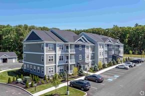 Boylston apartment for rent - a rendering of an apartment building with cars parked in a parking lot