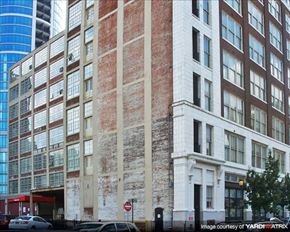 Philadelphia apartment for rent - a tall brick building with cars parked in front of it